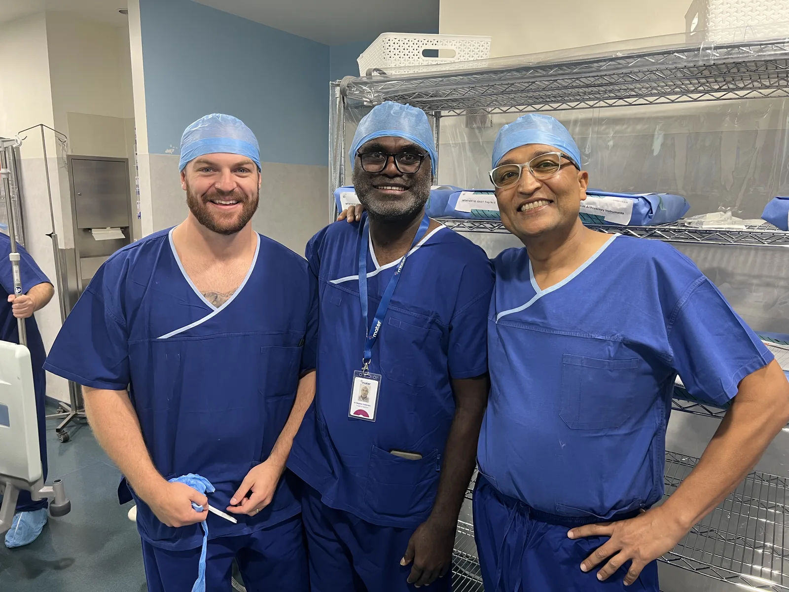 Dr. Kosh with his orthopaedic surgical team in theatre scrubs before a knee procedure
